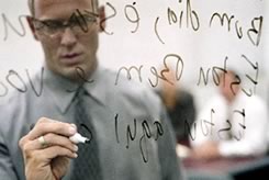 Person writing on glass board