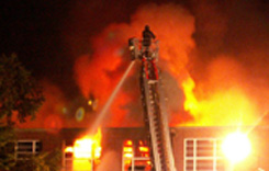 Firefighter on Ladder Over Fire