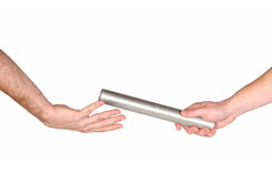 Hands passing a baton