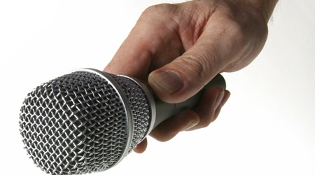 Hand holding microphone