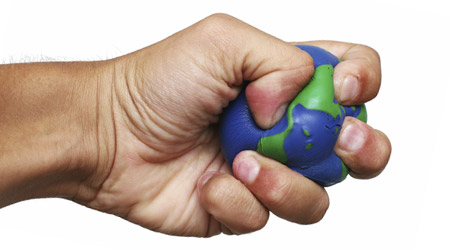 A hand squeezing a rubber globe