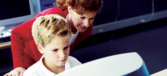 Student and teacher working at computer