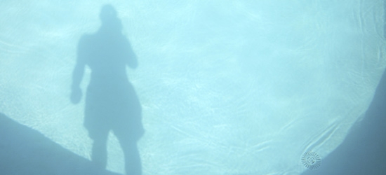 Reflecting of a person in a pool